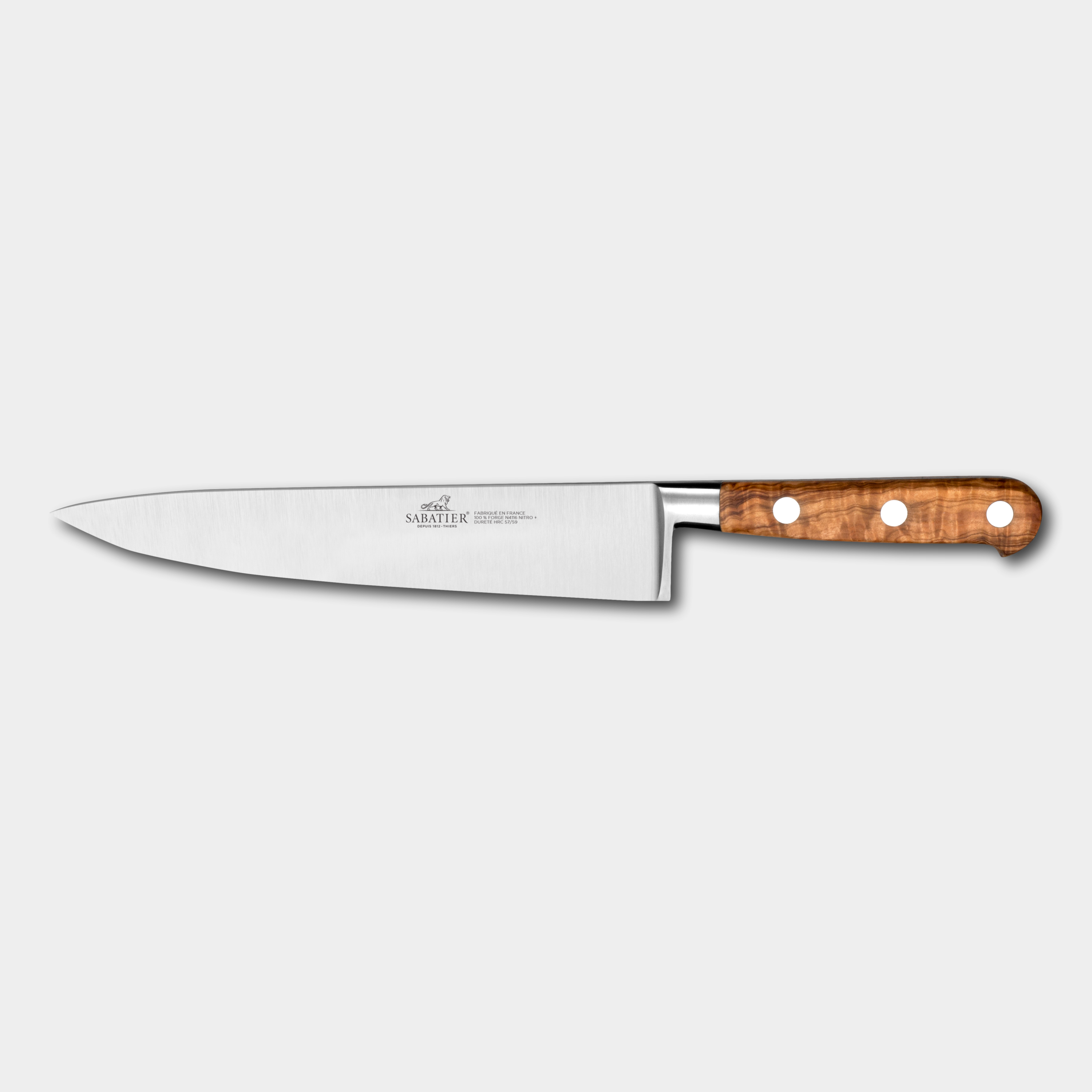 Chef's knife with a olivewooden handle on a light gray background
