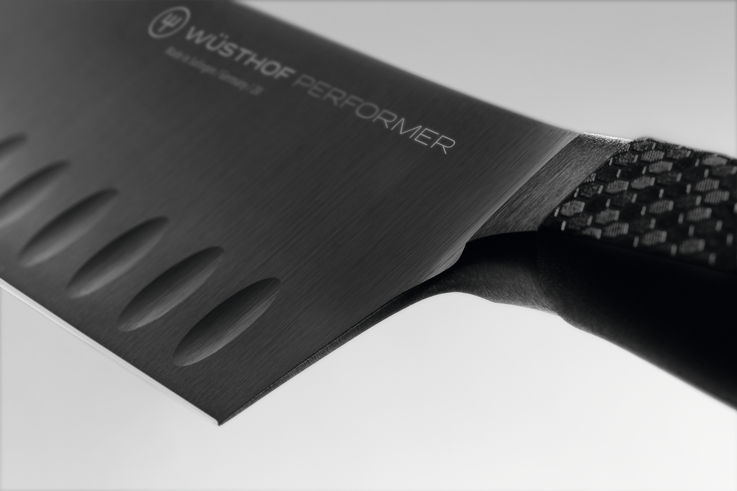 Wusthof Perfomer 17cm Rotoku knife with diamond like carbon coating and honeycombe handle by The Cotswold Knife Company