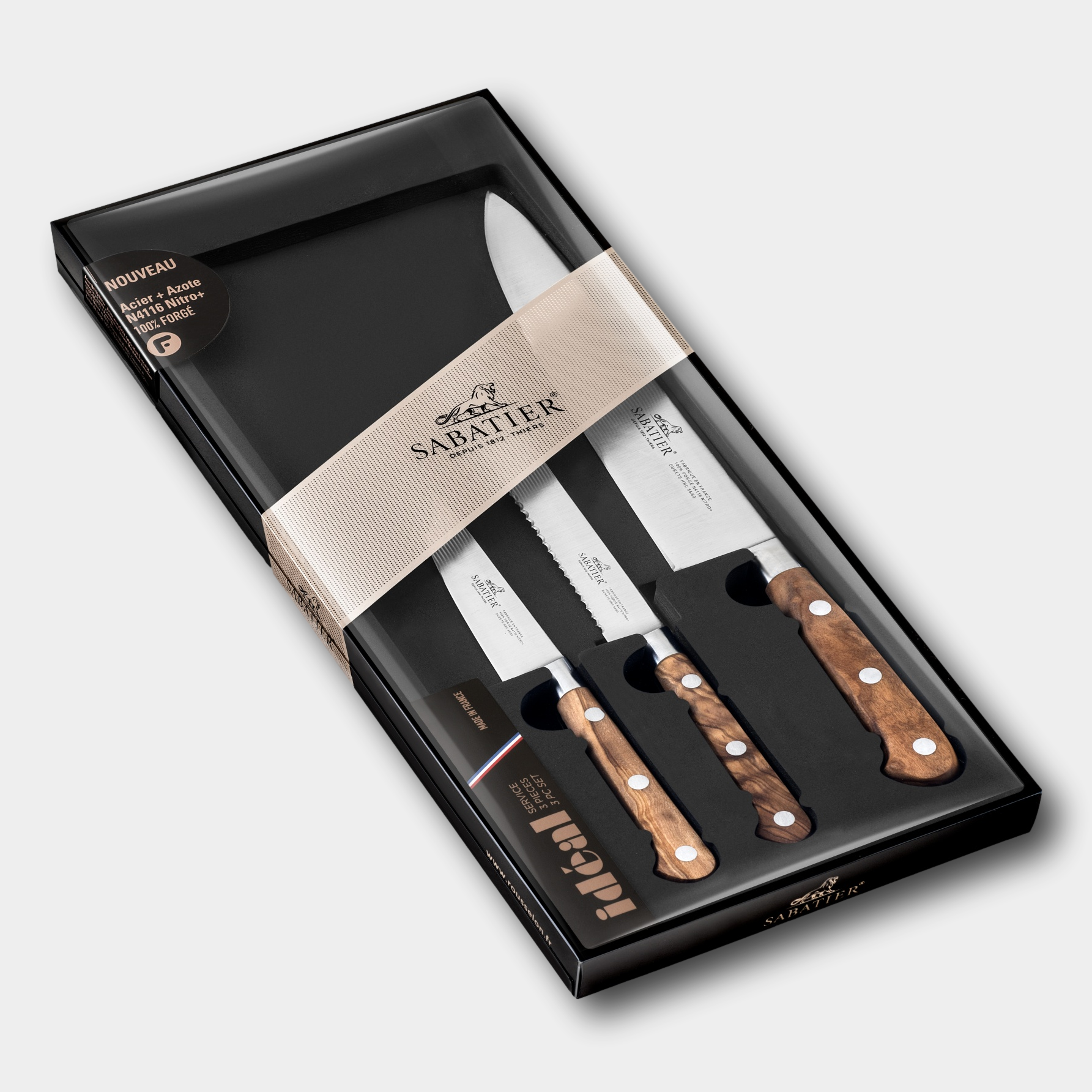 Set of knives with wooden handles in a black box, featuring the Sabatier brand.